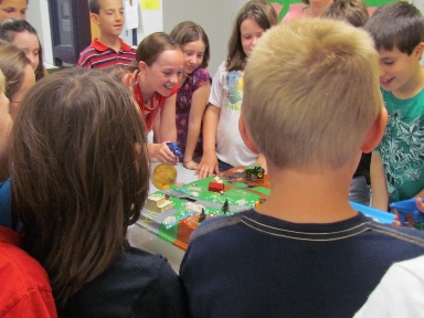 Clough Elementary School 4th graders 'raining' on the watershed model